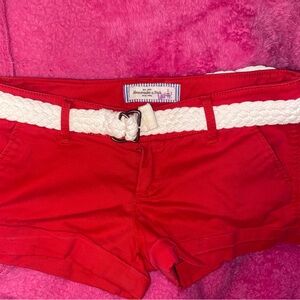 Red denim shorts with knit belt